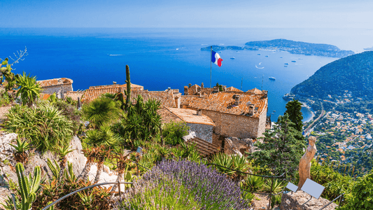 Scenic view of the South of France with rolling hills, sunlit villages, and a clear blue sky
