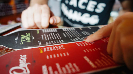 A hand passes over a menu with a lot of options