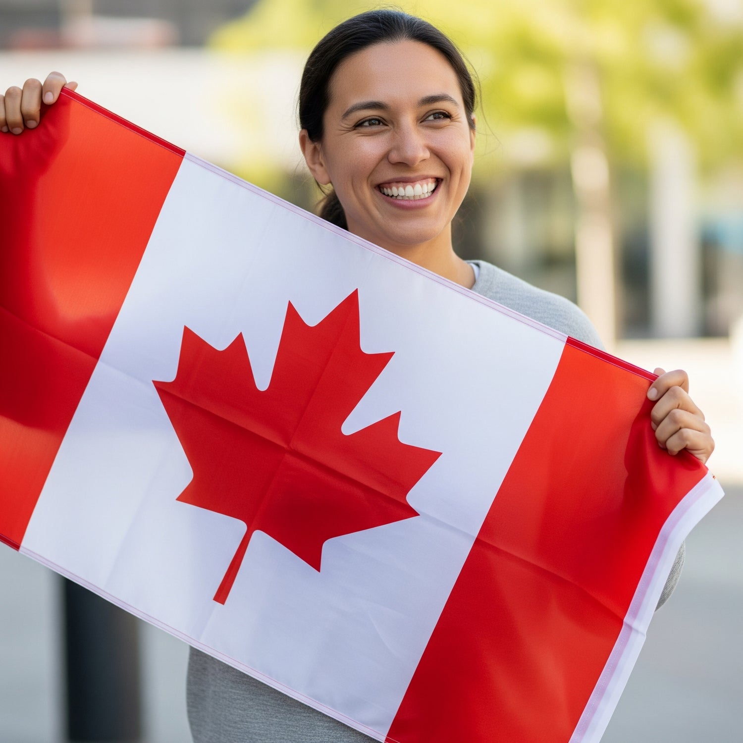 Woman holding a Canadian flag outdoors