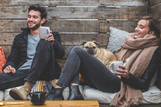 Smiling woman and man with a pug